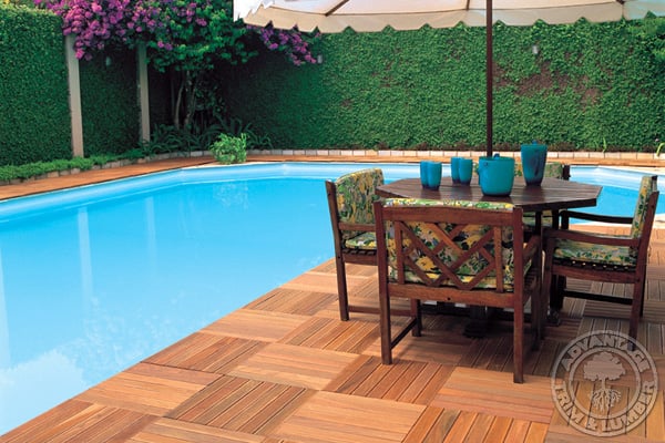 A pool area is complete with Advantage Lumber, LLC deck tiles.