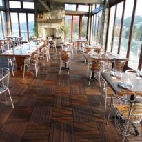 Ipe wood is so hard the chair legs in this dining room will not scratch the surface of our decking tiles.