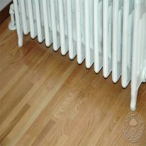 Oak Flooring with a radiator in the background.