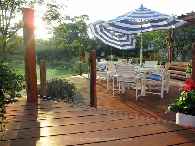 cumaru deck with glass panel railings and umbrellas